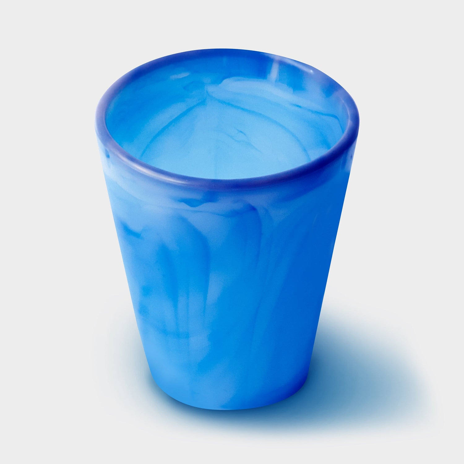 Eco-friendly GoSili cup with drink, promoting ocean clean-up donations.
