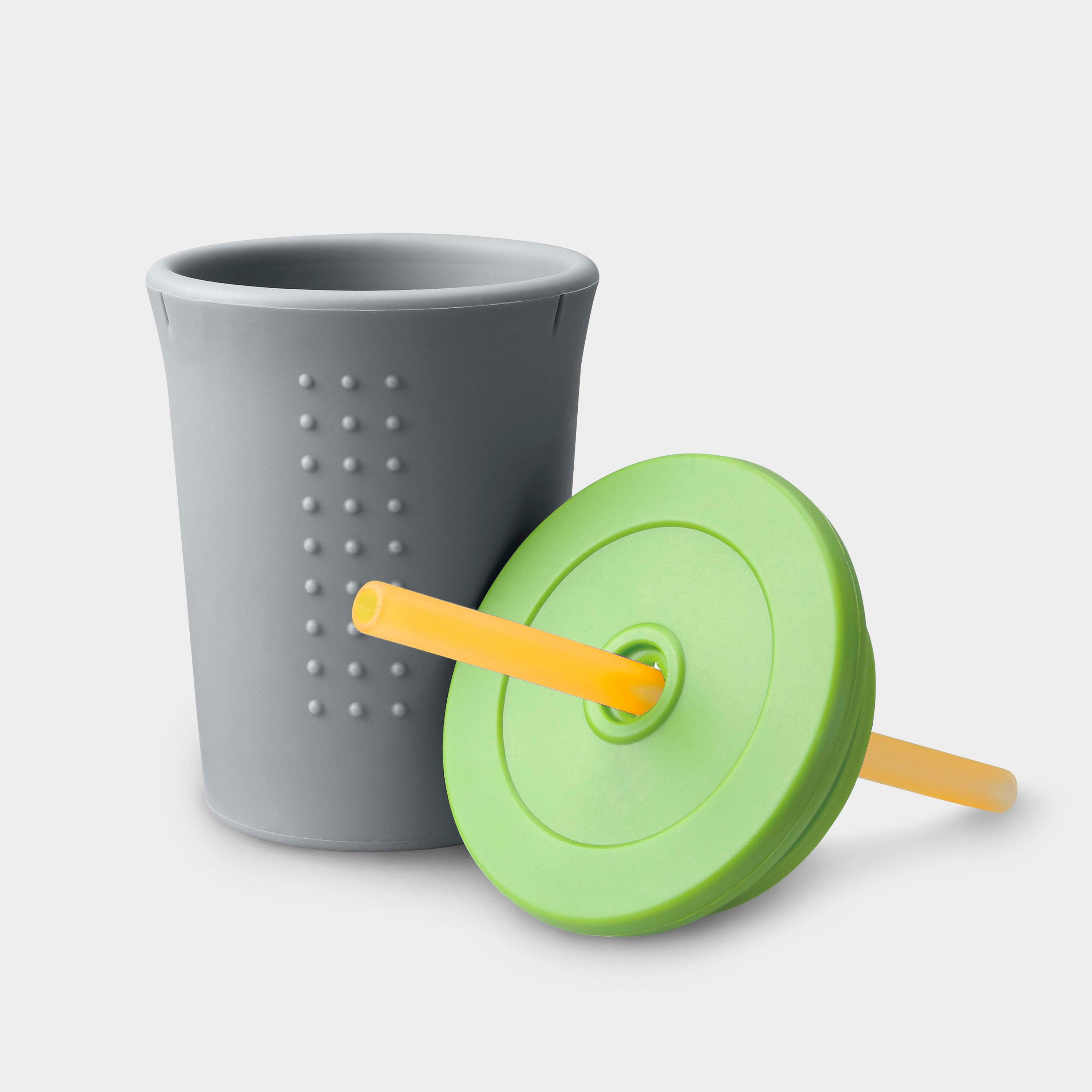 Reusable GoSili cup and straw in a modern kitchen, promoting sustainable living.
