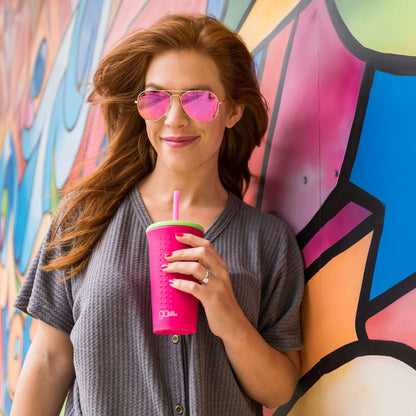 Person enjoying a beverage in a GoSili reusable silicone cup with a soft silicone straw.