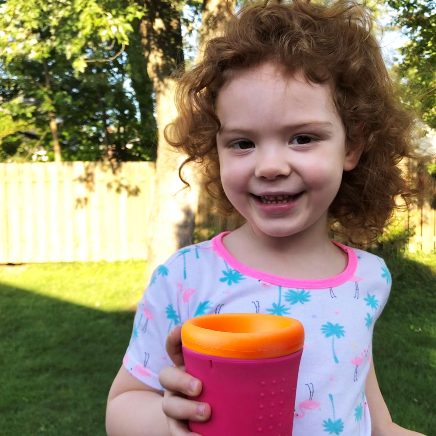 Parent and child enjoying spill-proof drinks with reusable silicone cups.