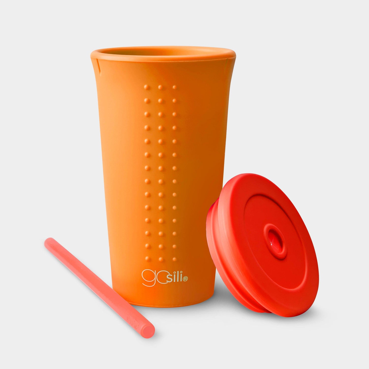 On-the-go sustainable silicone cup with lid and straw, perfect for outdoor adventures.
