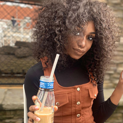 Person enjoying a smoothie with a soft and flexible GoSili reusable silicone straw, eco-friendly and non-toxic.
